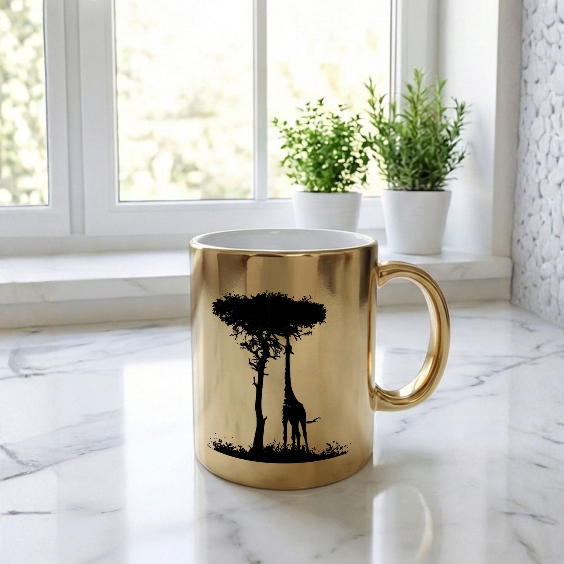 Gold mug with a black silhouette of trees and a giraffe on a marble surface with plants in the background.