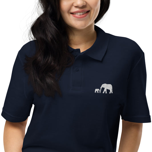 Black and navy unisex polo shirts featuring white embroidered design of a mother elephant walking with her baby calf in a minimal luxury wildlife style.